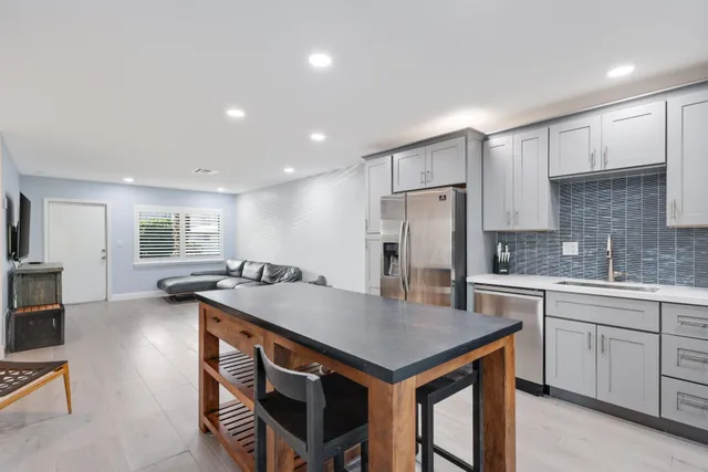 a view of a chair and table in backyard of the house