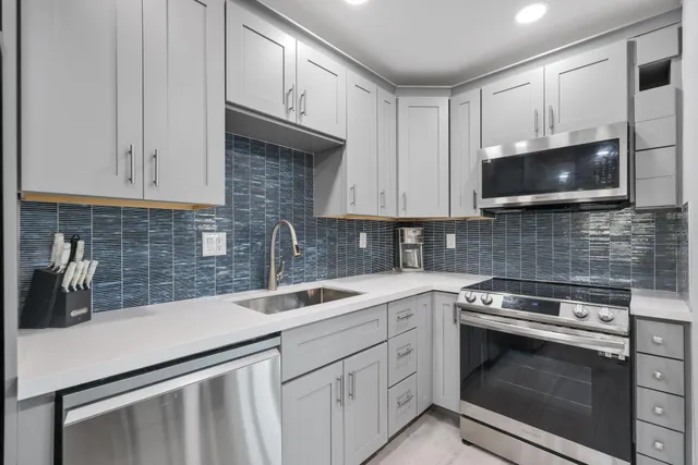 a palm tree sitting in front of a house with a big yard