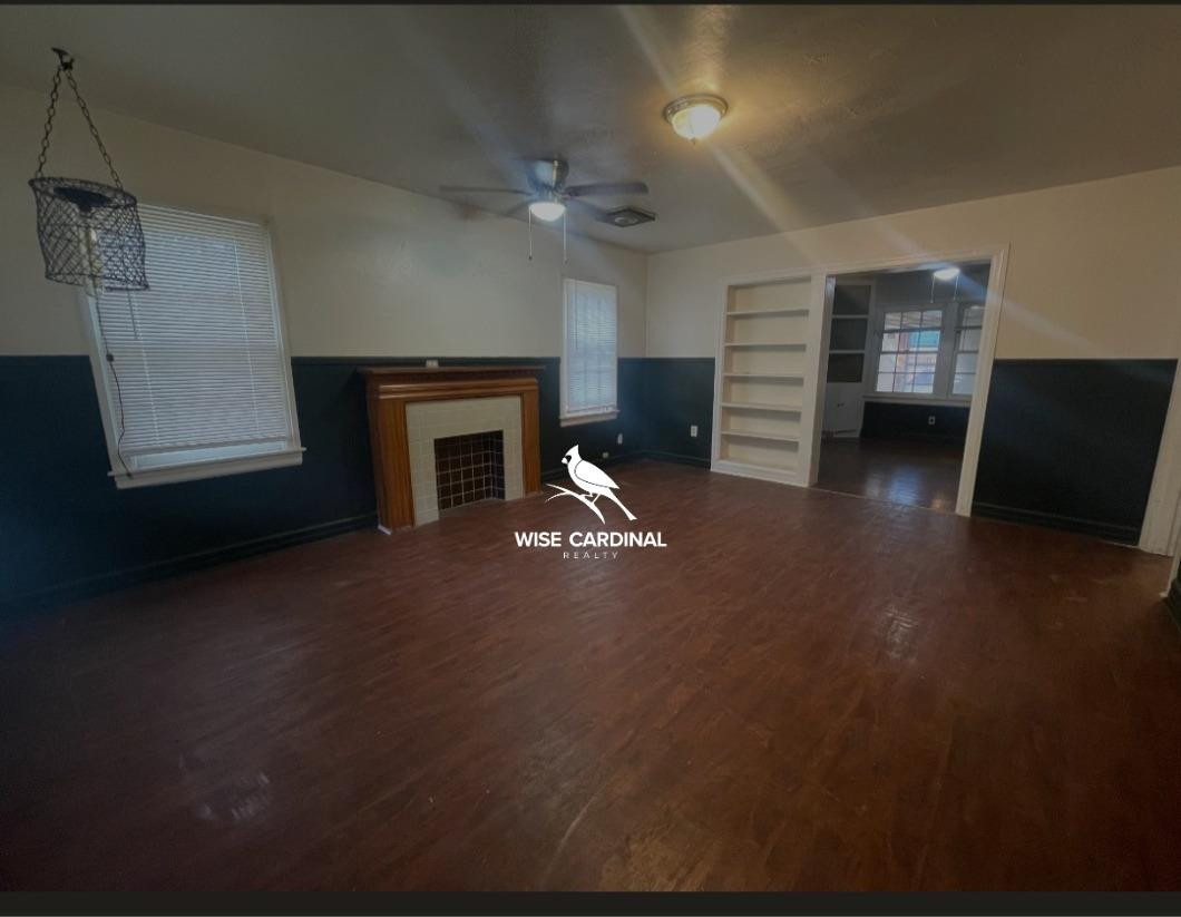 1726 25th Street Lubbock, TX 79411 - Photo 3 of 11 a living room with furniture and a fireplace