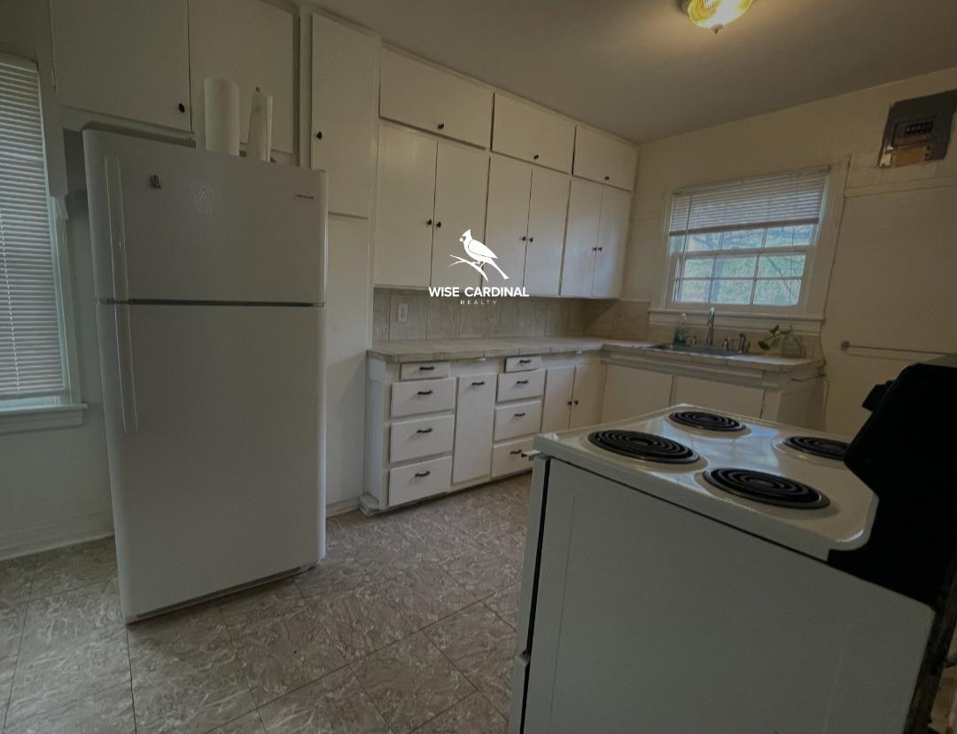 1726 25th Street Lubbock, TX 79411 - Photo 5 of 11 a kitchen with cabinets and appliances