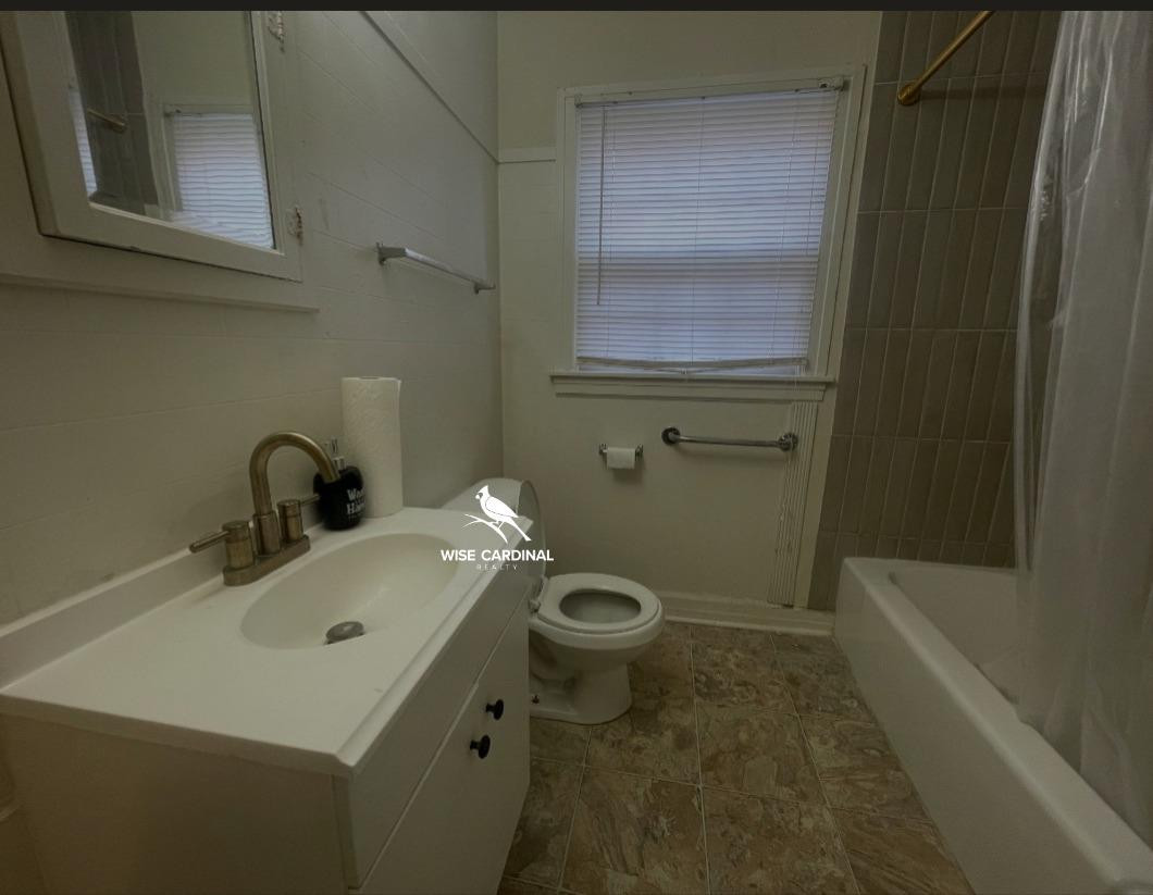 1726 25th Street Lubbock, TX 79411 - Photo 9 of 11 a bathroom with a sink a toilet and shower
