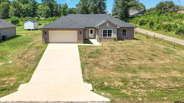 a house that has a tree in front of it
