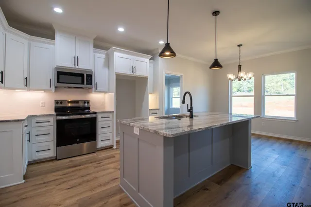 an empty room with a window and a ceiling fan