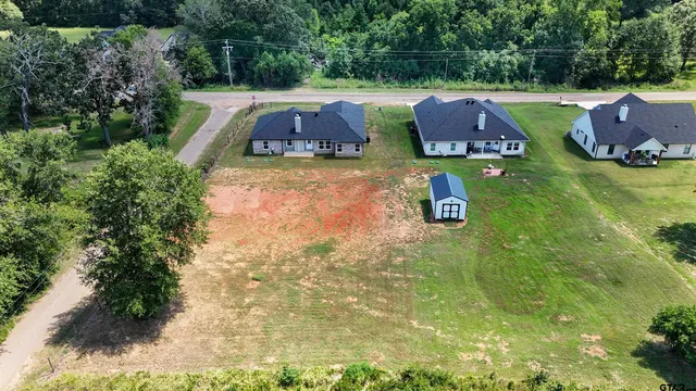 a aerial view of a house with a yard