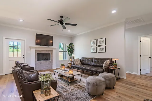an empty room with wooden floor windows and a chandelier