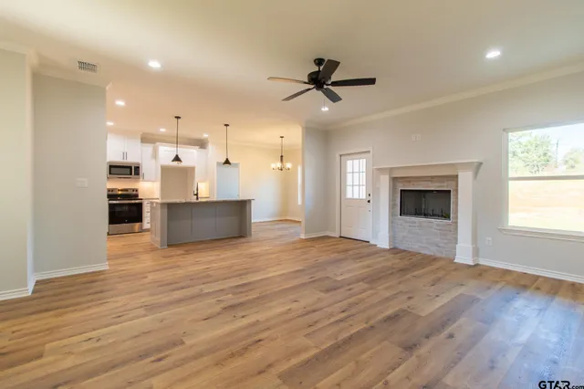 a kitchen with stainless steel appliances granite countertop a stove and a refrigerator