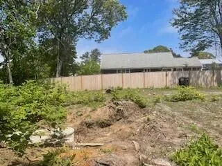 a backyard of a house with table and chairs