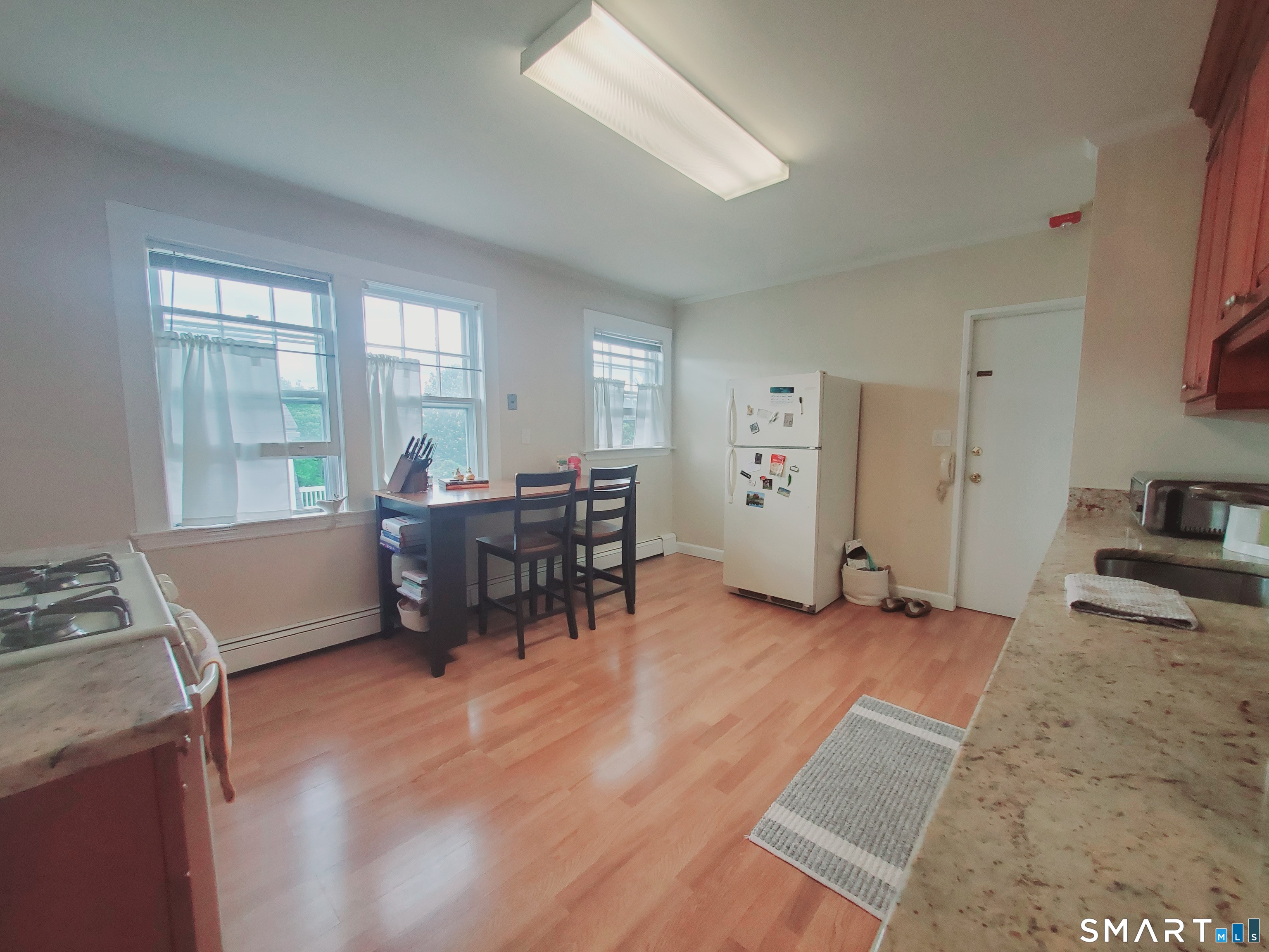 100 Colonial Road, Unit 2 Stamford, CT 06906 - Photo 2 of 8 a view of a workspace with furniture and a window