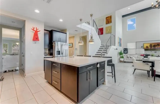 a kitchen with stainless steel appliances kitchen island granite countertop a table and chairs in it