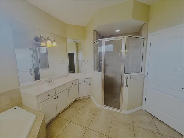 a spacious bathroom with a shower and a sink