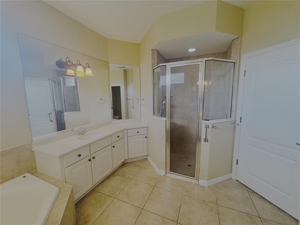 4940 Southwest 63rd Loop Ocala, FL 34474 - Photo 16 of 45 a spacious bathroom with a shower and a sink