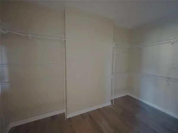 a view of a room with wooden floor