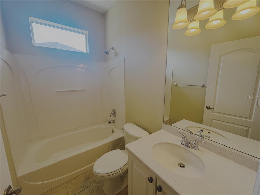 4940 Southwest 63rd Loop Ocala, FL 34474 - Photo 22 of 45 a bathroom with a sink toilet and shower