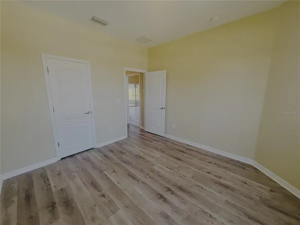 a view of room with wooden floor