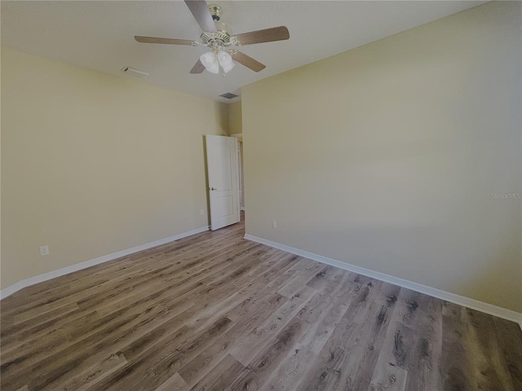 4940 Southwest 63rd Loop Ocala, FL 34474 - Photo 28 of 45 a view of room with hardwood floor and ceiling fan