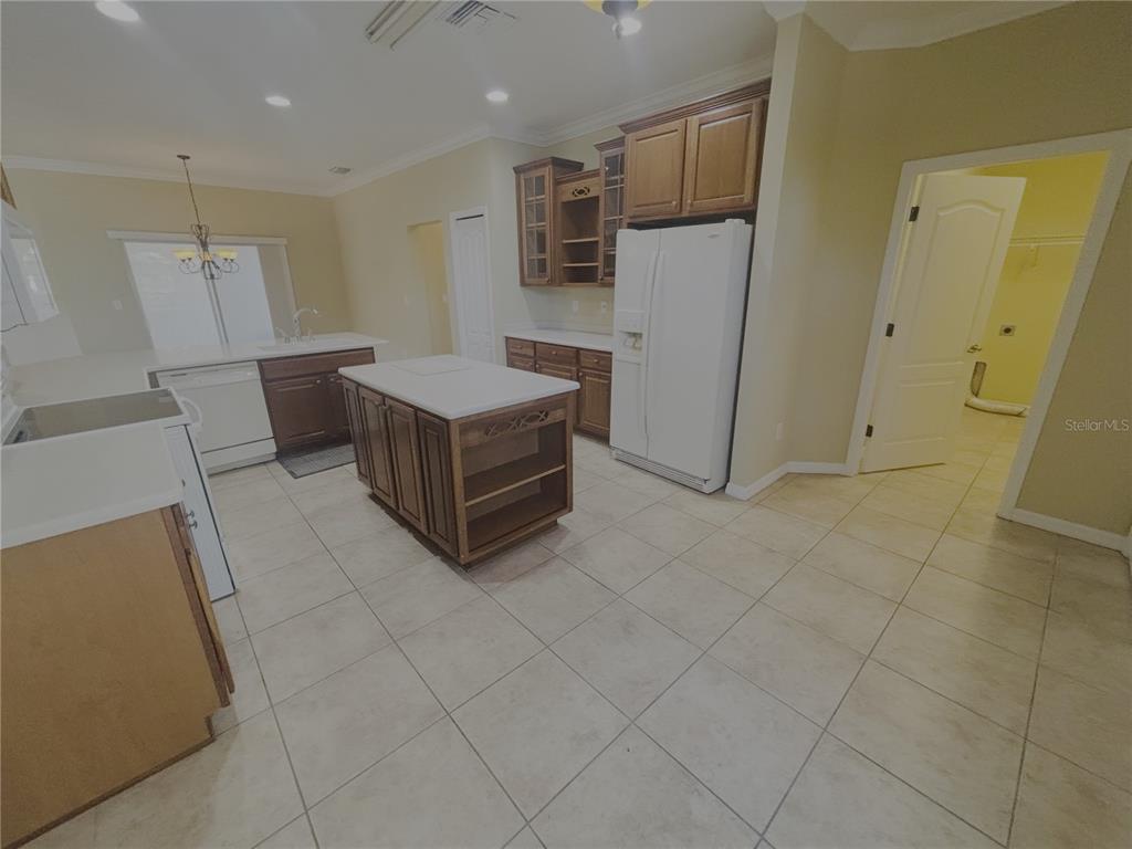 4940 Southwest 63rd Loop Ocala, FL 34474 - Photo 8 of 45 a room with a washing machine and a refrigerator