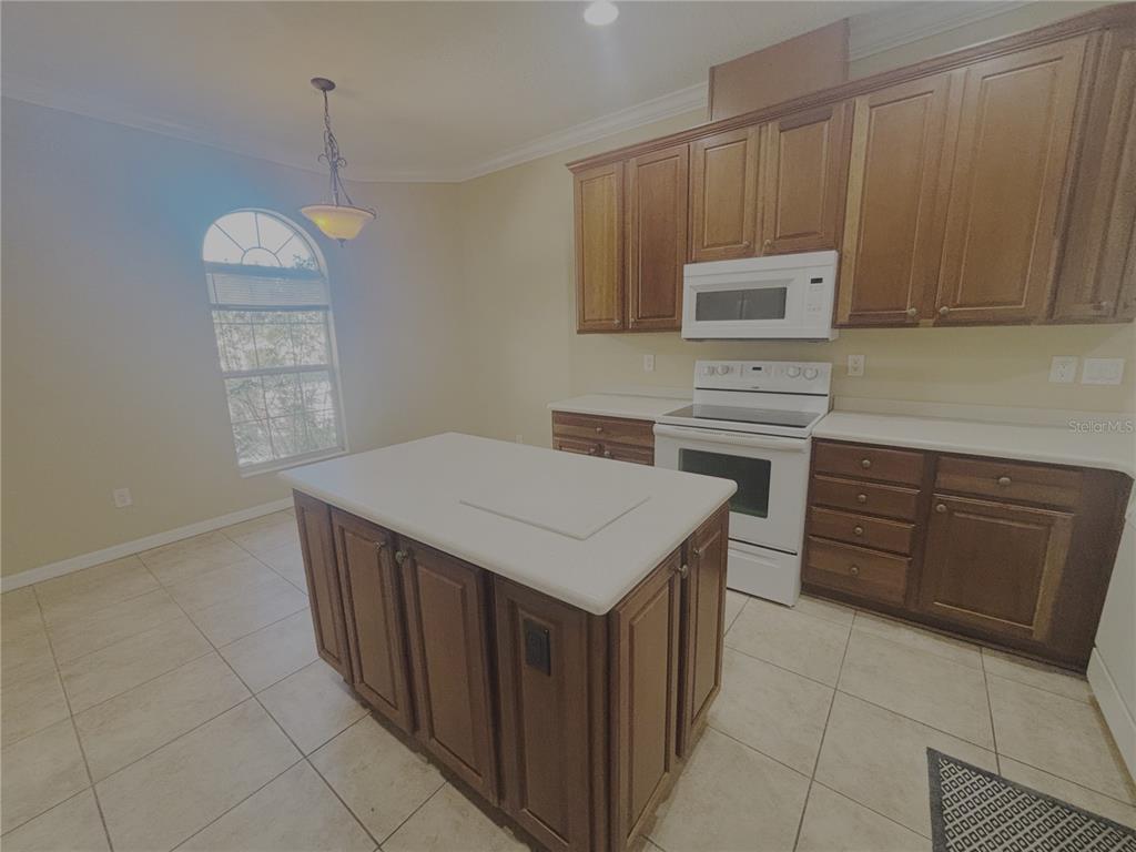 4940 Southwest 63rd Loop Ocala, FL 34474 - Photo 10 of 45 a kitchen with a cabinets and stove