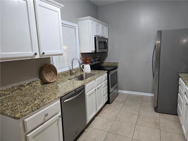 a kitchen with a sink stove and refrigerator