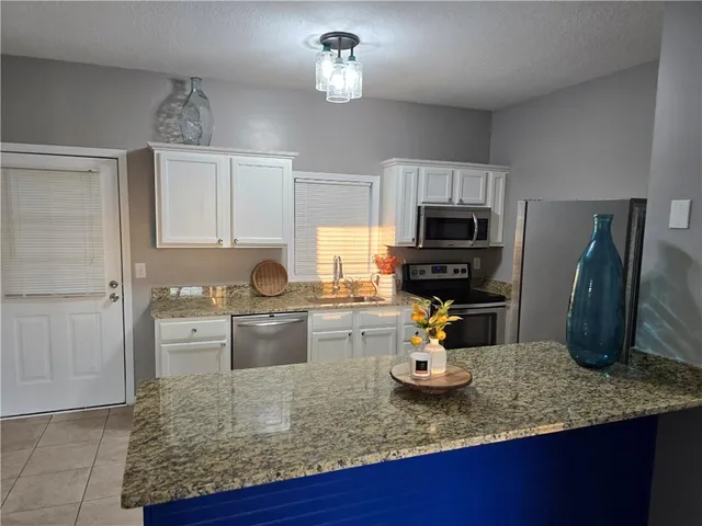 a kitchen with a refrigerator and a sink