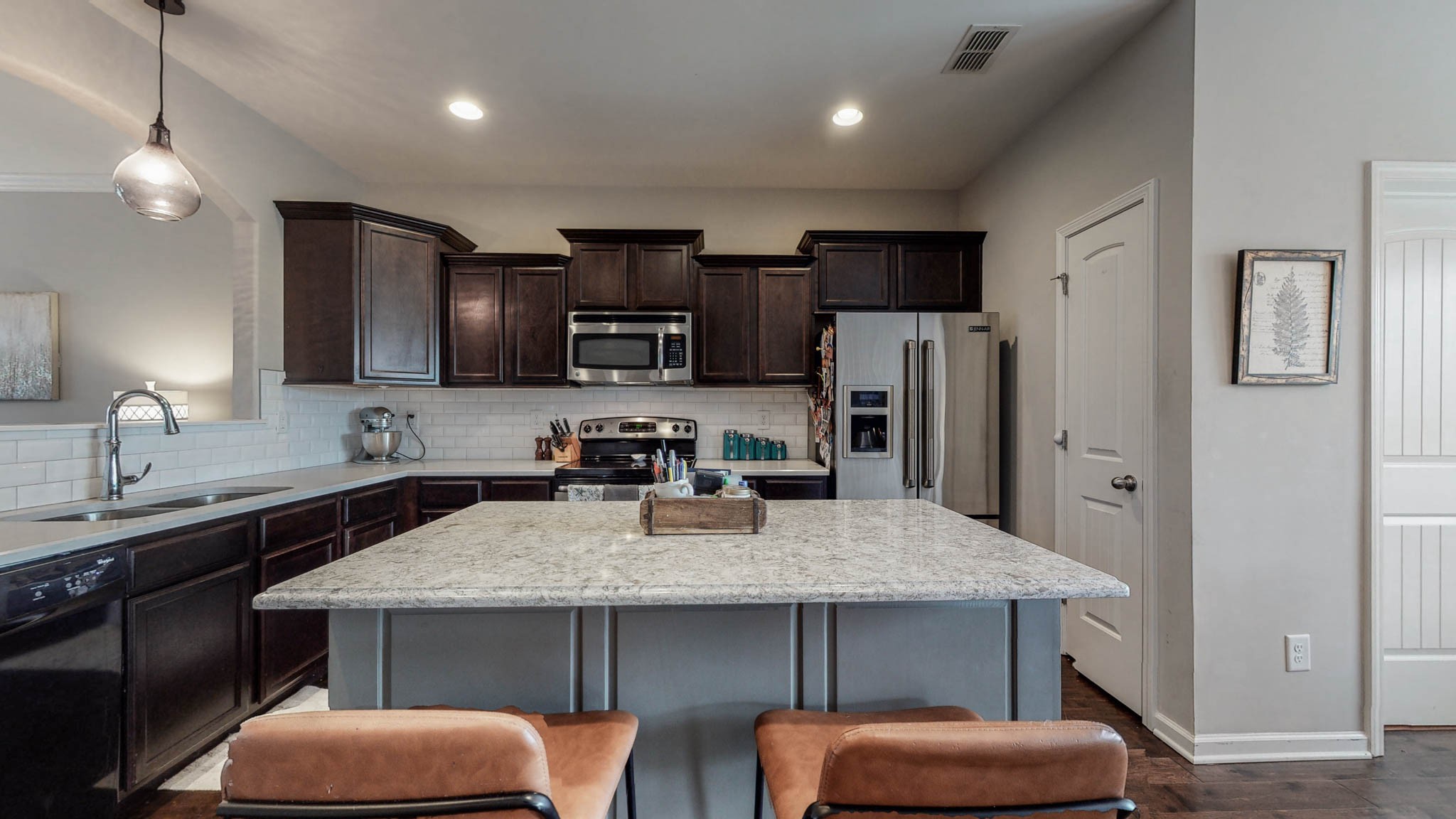 1115 Golf View Way Spring Hill, TN 37174 - Photo 8 of 49 a kitchen with stainless steel appliances a sink table and chairs