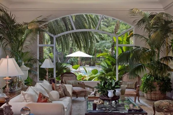 a backyard of a house with lots of green space and fountain