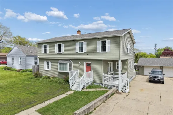 a front view of house with yard and green space