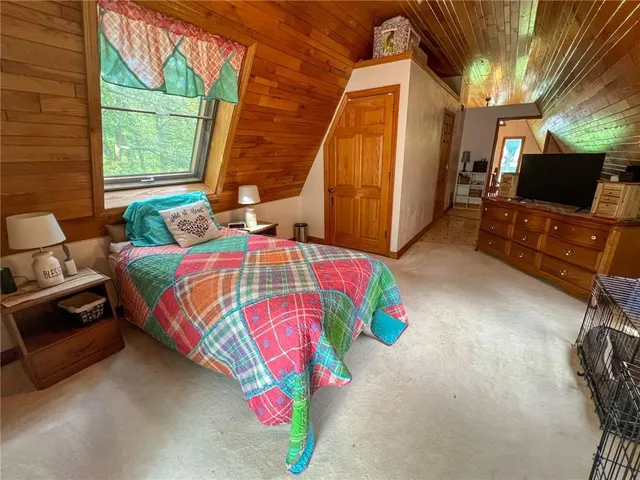 a bedroom with a bed next to a window