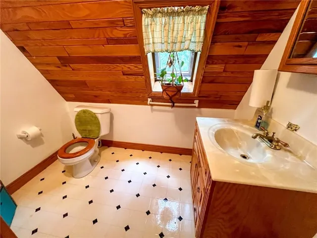 a bathroom with a sink mirror vanity and toilet