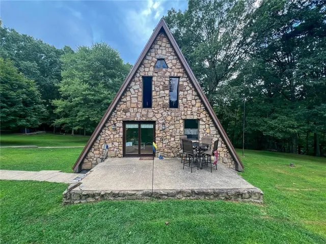 a view of a house with a yard balcony and entertaining space