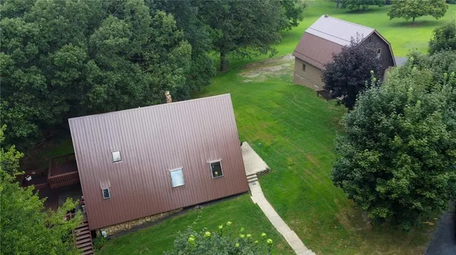 an aerial view of a house with a yard and lake view
