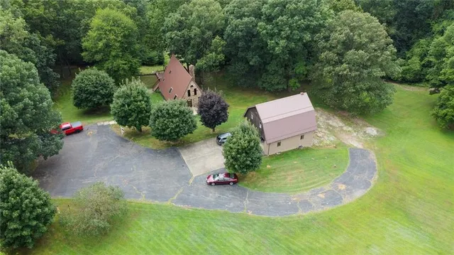 a view of backyard with a barn and a table and chairs