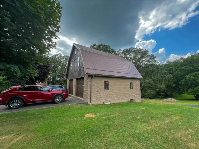a house with green field in front of it
