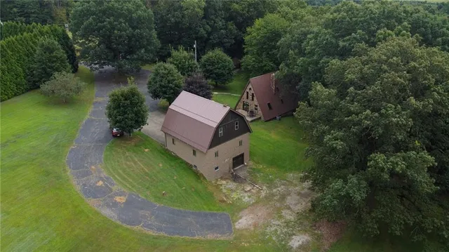 an aerial view of a house with a yard