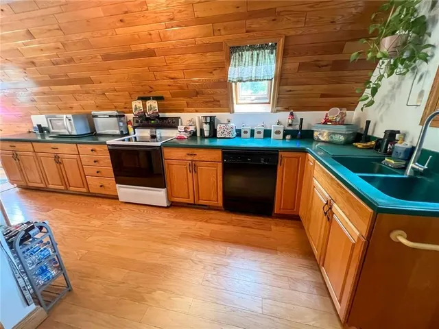 a kitchen with stainless steel appliances granite countertop a sink counter space and cabinets