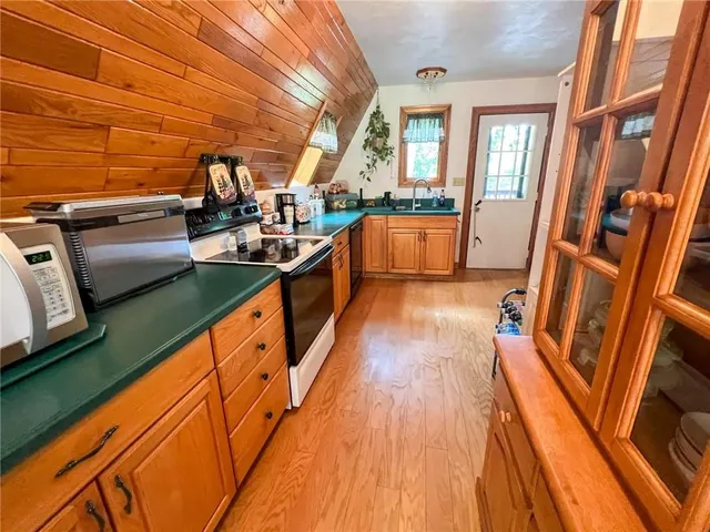 a view of a open kitchen with a large window