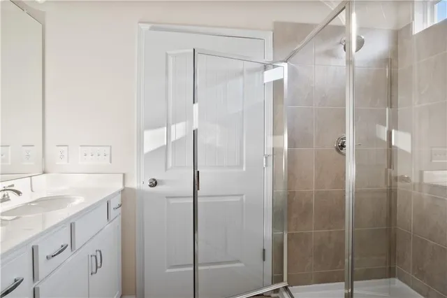 a bathroom with a shower sink and mirror