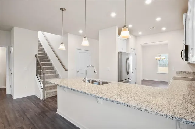 a bathroom with a sink a large mirror and vanity