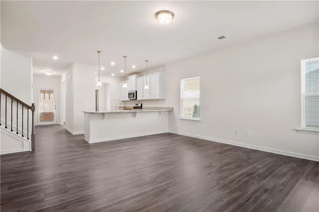 a view of kitchen with wooden floor and window