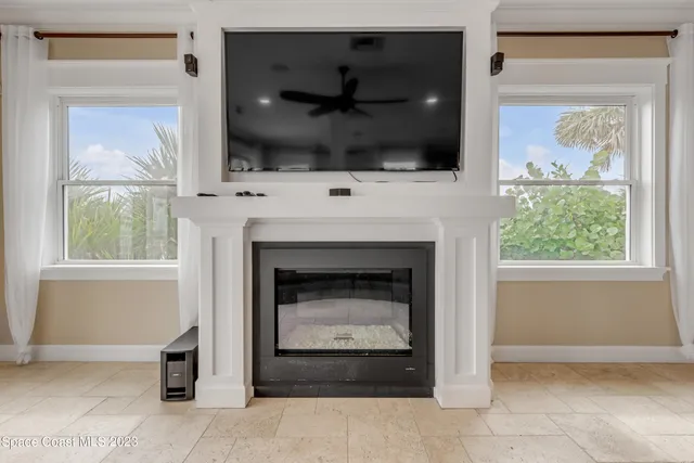 a view of a livingroom with a flat screen tv ceiling fan and a ceiling fan