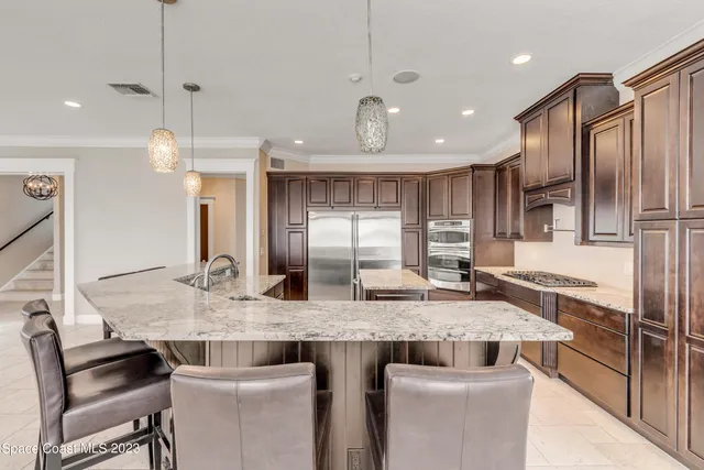 a bathroom with a granite countertop double vanity sink and mirror