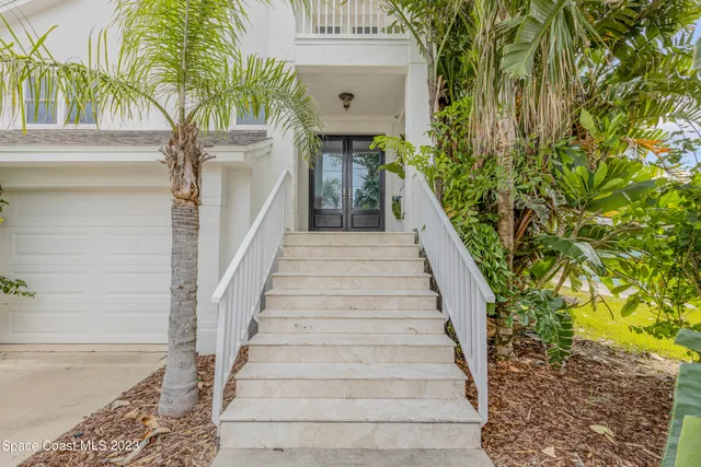 a kitchen with kitchen island granite countertop wooden cabinets and a refrigerator