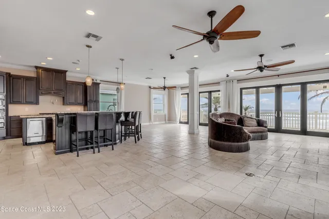 a kitchen with kitchen island granite countertop a sink window and cabinets
