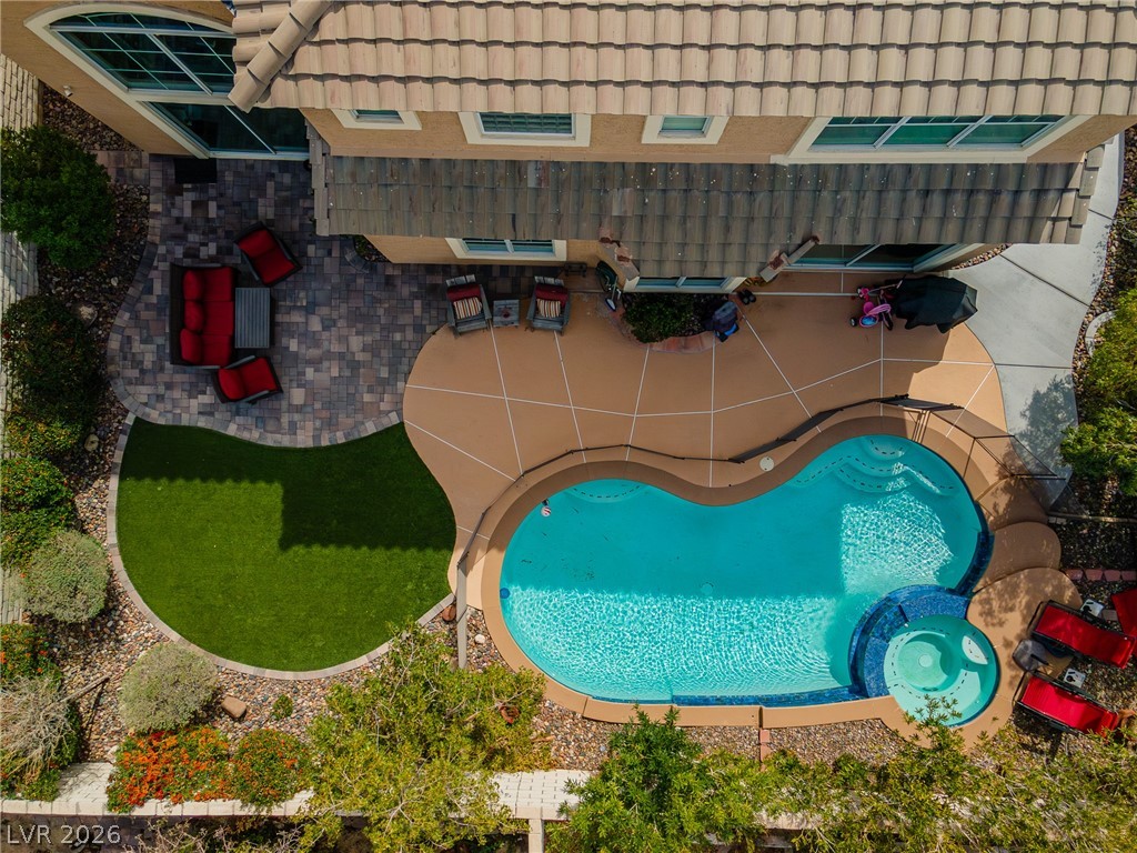 2504 Putting Green Drive Henderson, NV 89074 - Photo 45 of 56 This outdoor oasis features a private pool with a spa, inviting relaxation.