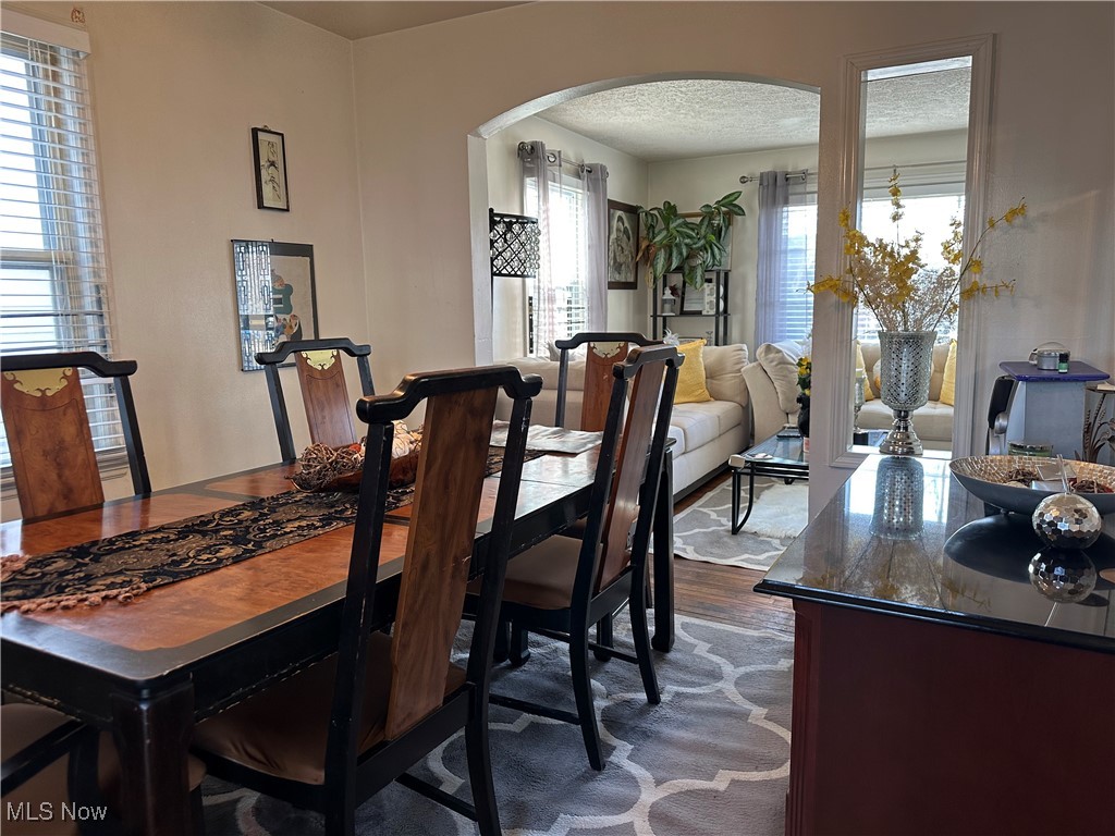 19315 Libby Road Maple Heights, OH 44137 - Photo 6 of 29 Dining area featuring arched walkways and a textured ceiling