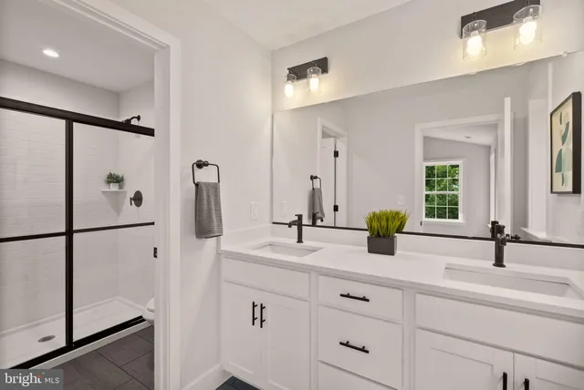 a living room with furniture potted plant and white walls