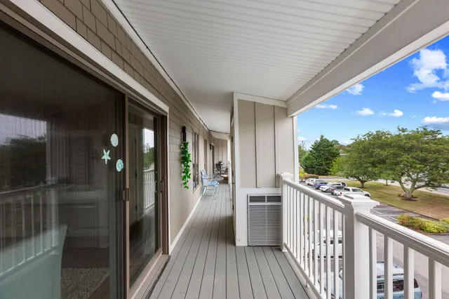 a view of a balcony with wooden floor