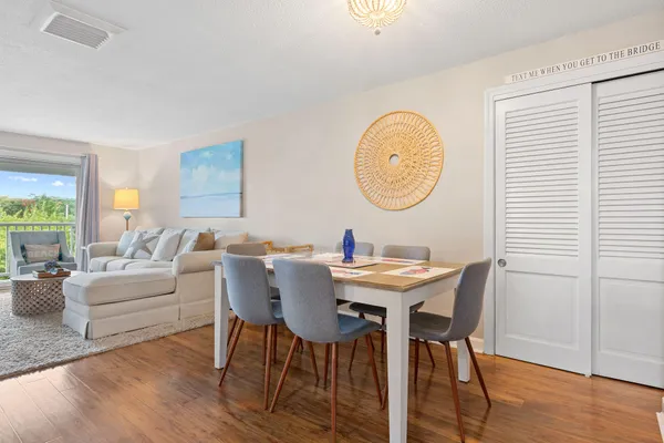 a view of a dining room with furniture and wooden floor