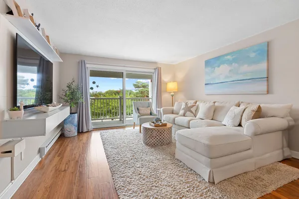 a living room with furniture and a large window
