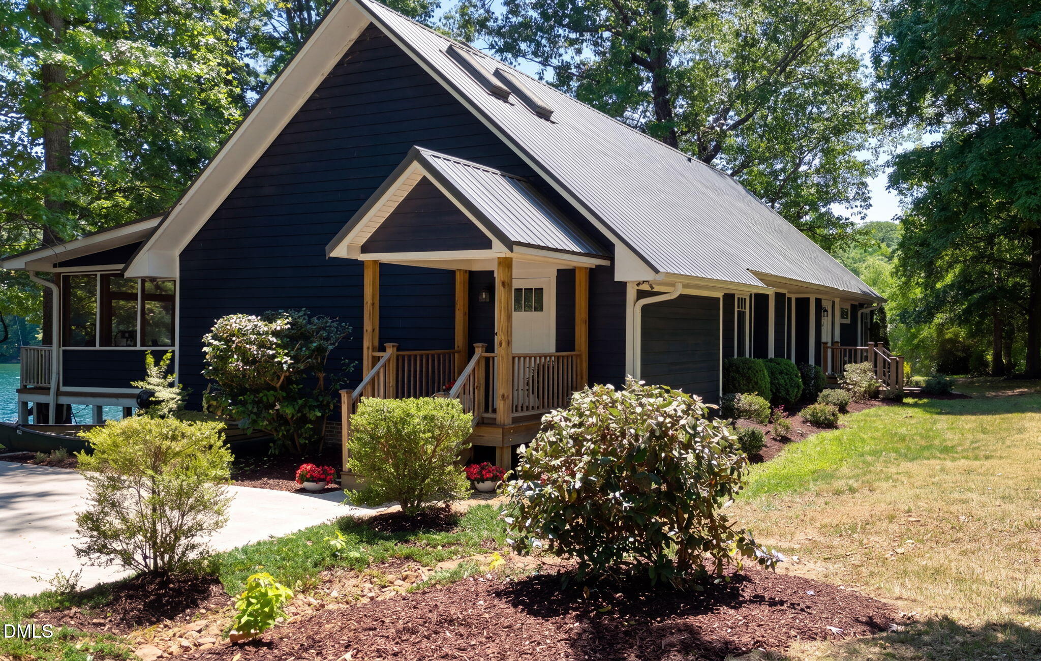 370 Robinson Ferry Road Macon, NC 27551 - Photo 18 of 85 a front view of a house with a yard and a garden