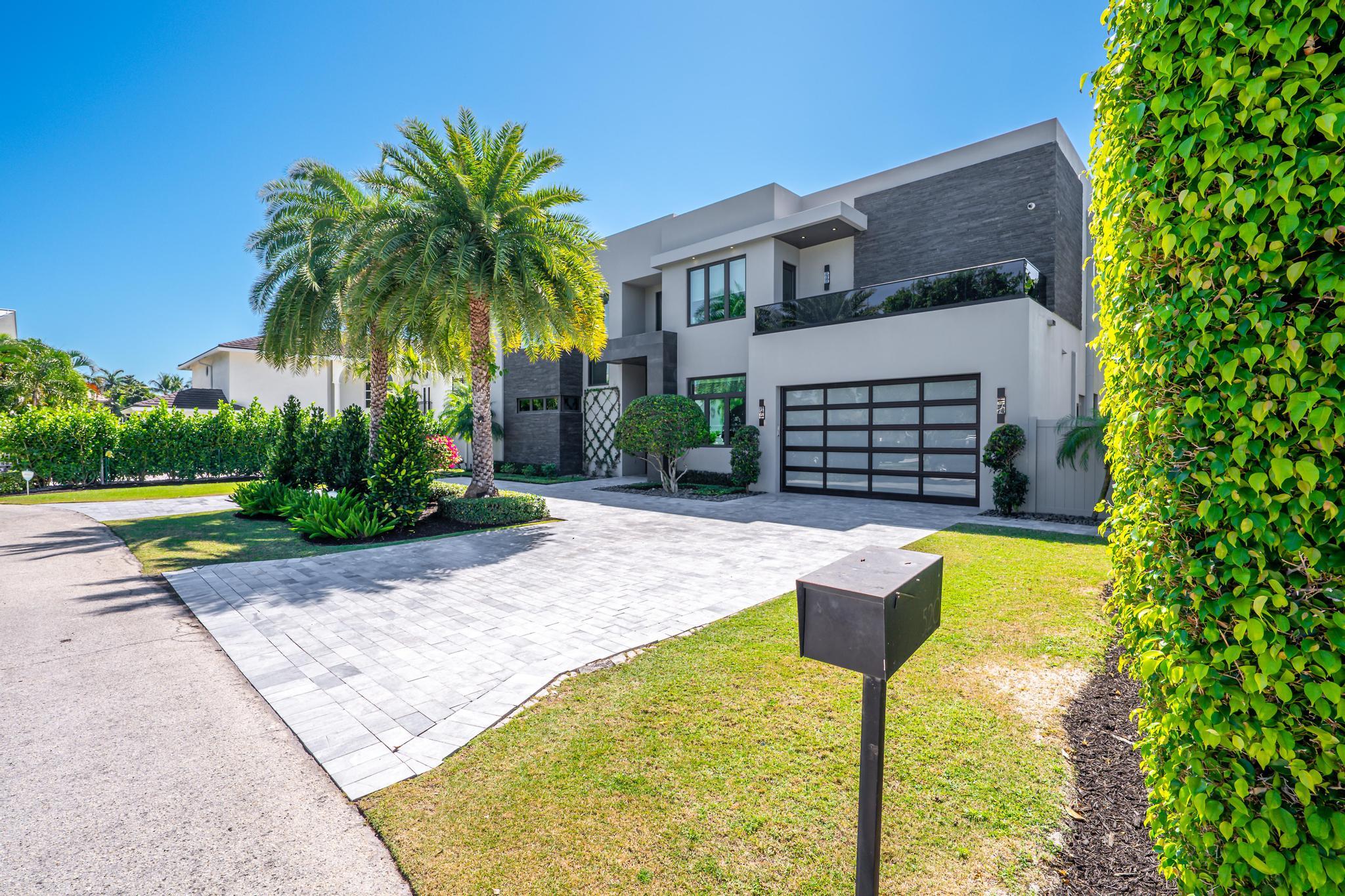 520 Northeast 4th Lane Boca Raton, FL 33432 - Photo 2 of 40 a front view of a house with swimming pool